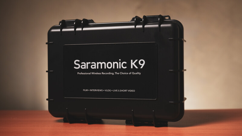 Saramonic K9 wireless recording system in black protective case against warm studio lighting.