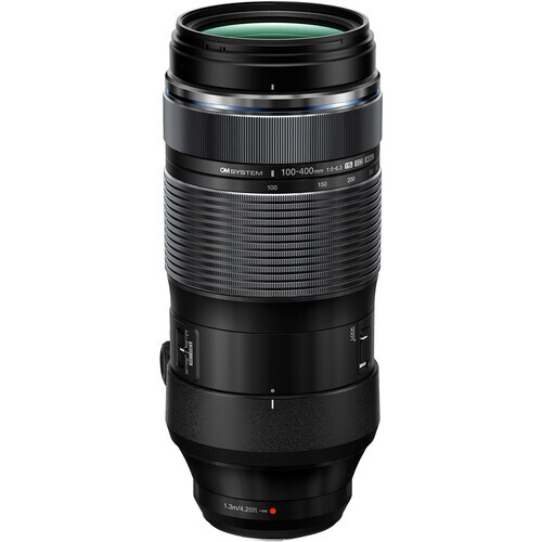Black telephoto zoom lens with ribbed barrel and green-tinted glass elements visible at the top.