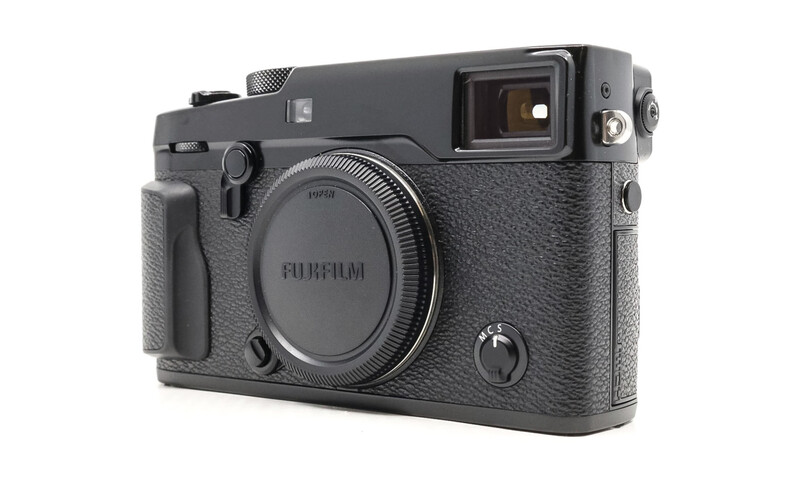 Fujifilm X-Pro3 rangefinder camera with textured black body and fixed lens, shown against white background.