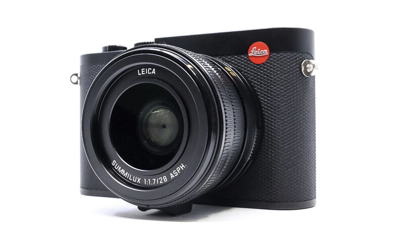 Leica Q2 rangefinder camera with black leather body and fixed 28mm lens on white background.