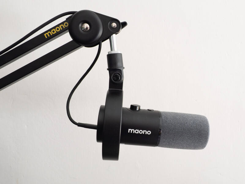 Maono microphone mounted on a boom arm with pop filter attached.