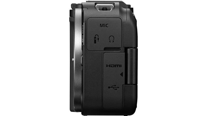 Side view of a compact digital camera showing ports including HDMI, USB, and microphone input.