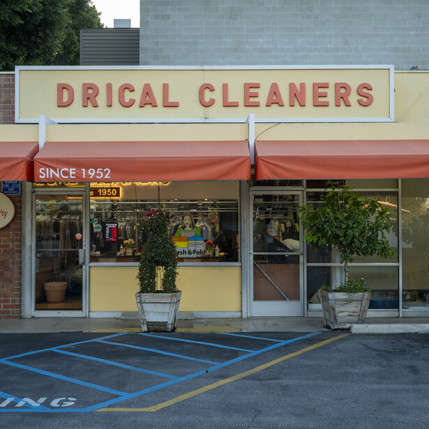 Storefront of Drical Cleaners with red awning and cream-colored signage, established since 1952.