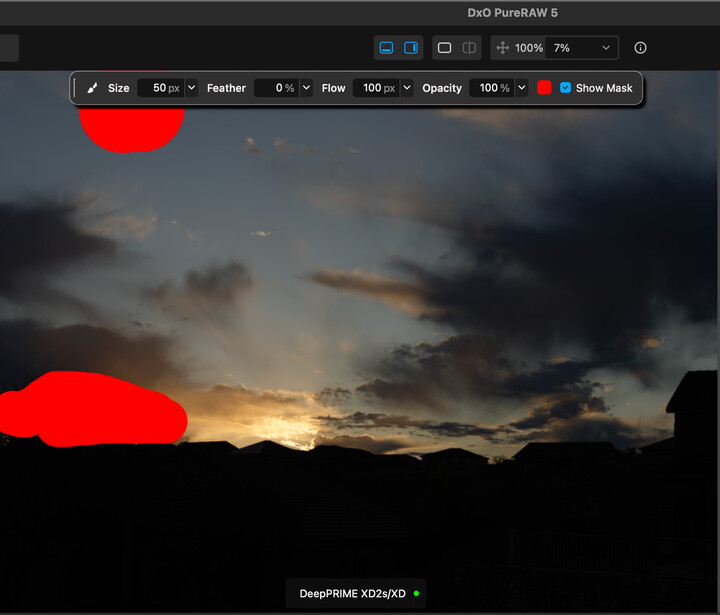 Screenshot of photo editing software showing a sunset landscape with red selection masks overlaid on the sky.