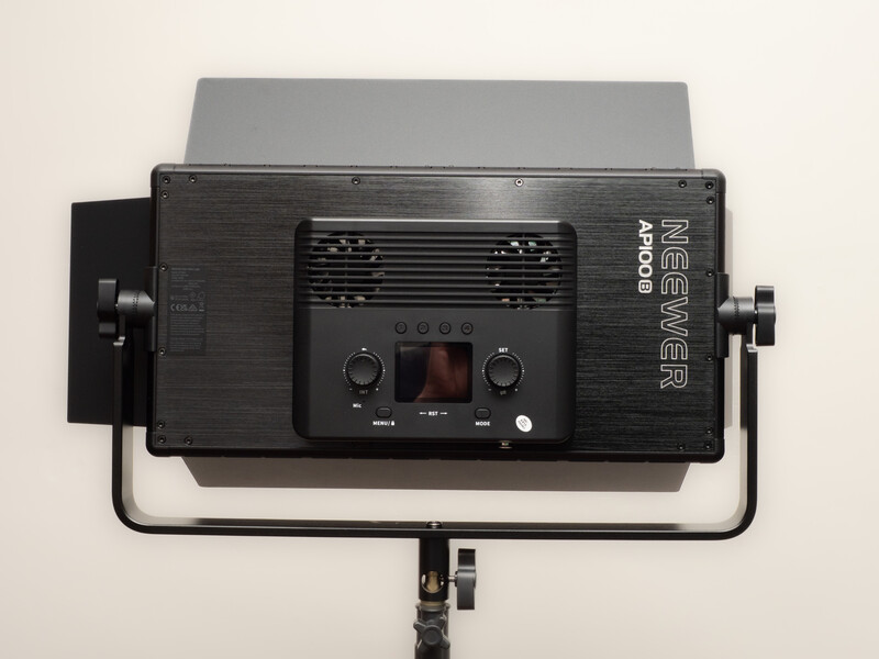 Front view of a professional LED panel light with dual cooling fans and control interface mounted on a stand.