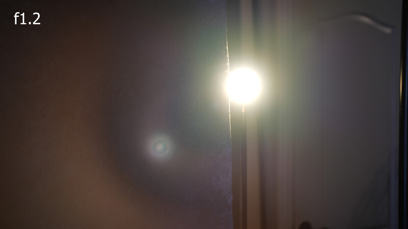 Bright street light at night with lens flare and bokeh effects against dark surroundings.