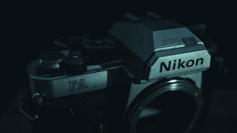 Nikon FA and FA camera bodies displayed against a dark background.