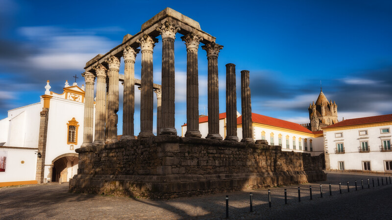 A long exposure images of streaking clouds over a roman ruin
