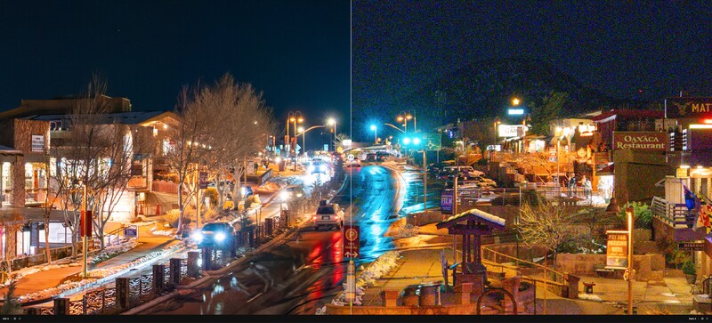 Night street scene with vehicle light trails creating blue and red streaks across urban storefronts and bare trees.
