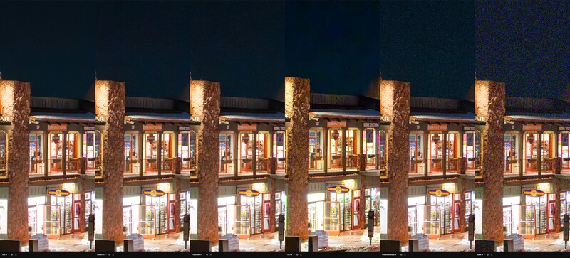 Nighttime architectural photograph of a modern building facade with repeating brick columns and illuminated storefronts.