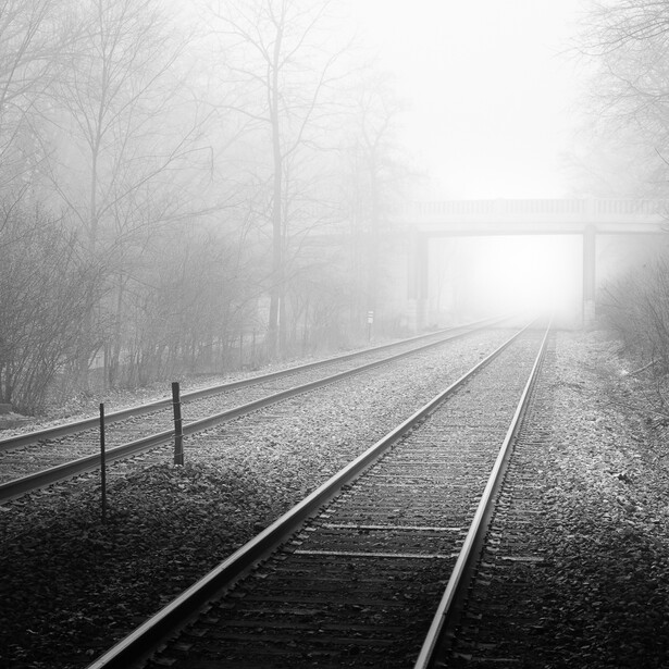 Photography of train tracks on a foggy day