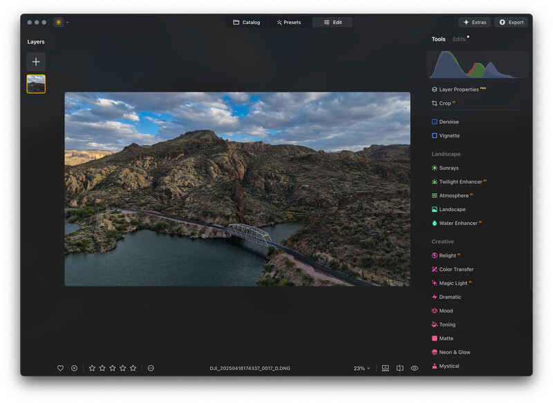 Screenshot of photo editing software showing aerial landscape image with mountains and river.