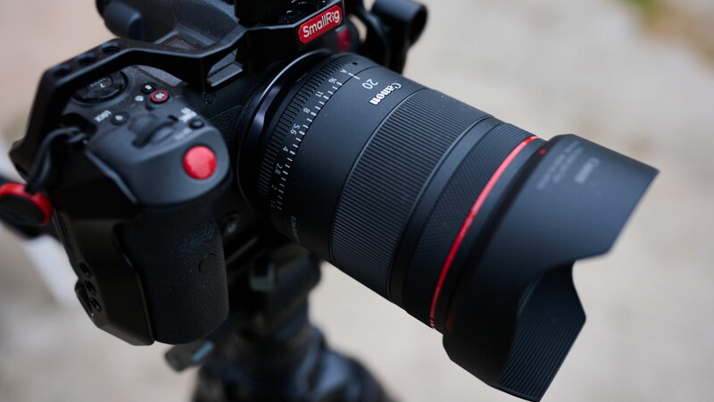 Professional cinema camera with wide-angle lens mounted on a stabilizer, showing red control buttons and professional imaging setup.
