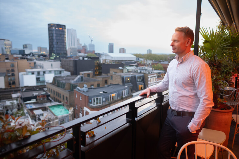 Stephen Neilson, Senior Product Manager for Photoshop looking out from a rooftop in London.