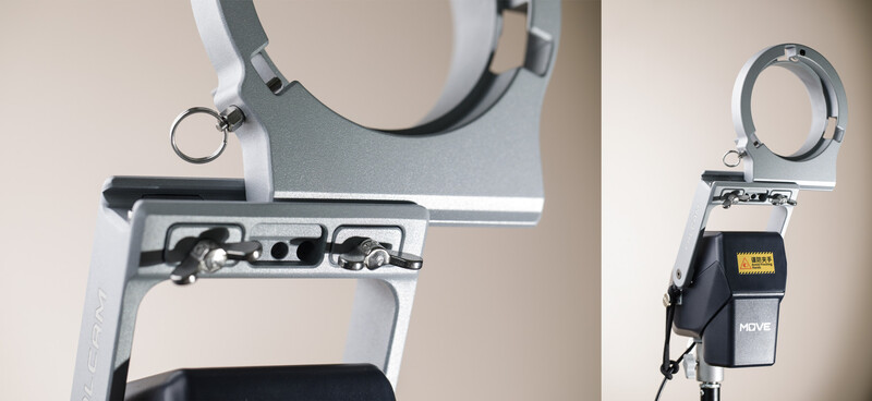 Close-up of white lens collar clamps with adjustment mechanisms and mounting hardware.