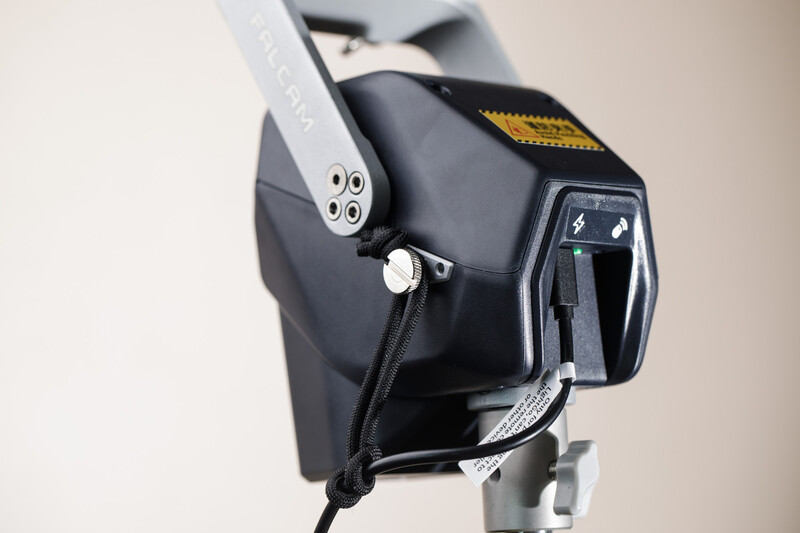 Soft box flash modifier with diffuser mounted on a studio light stand against neutral background.