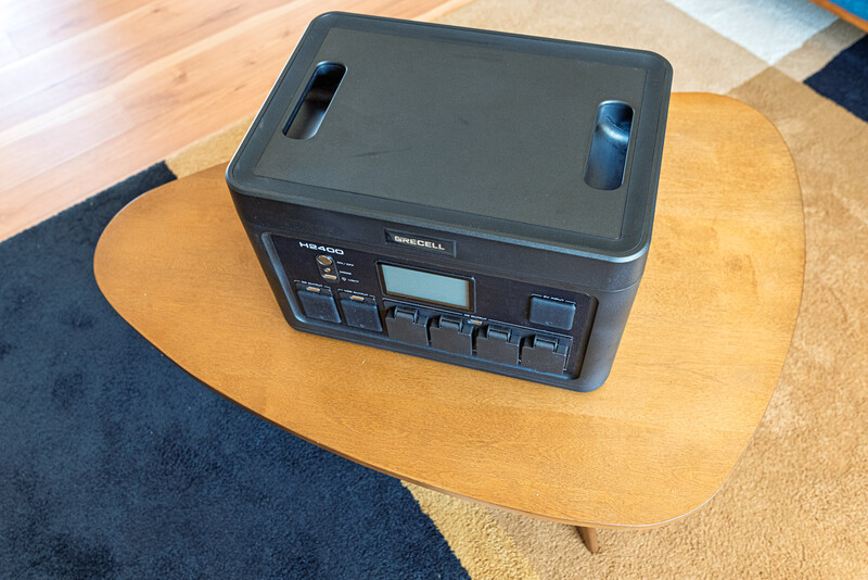 Portable power station with control panel displayed on wooden table indoors.