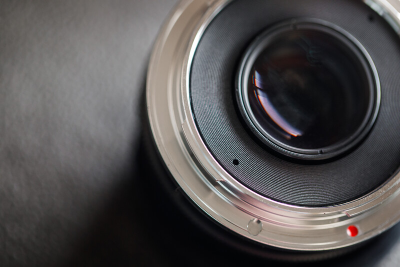 Close-up view of a camera lens mount showing glass elements and internal mechanics.