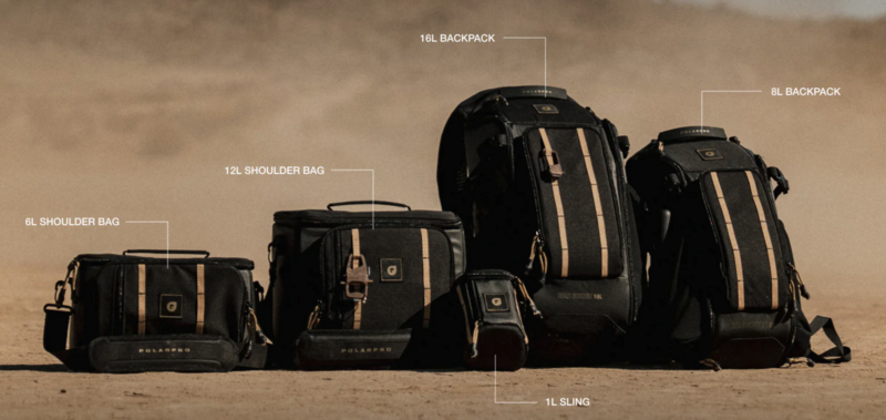 Four black camera bags with tan accents arranged by size on sandy ground, labeled with their capacities.