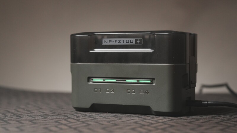 Nikon battery charger with dual charging slots and LED indicators on textured surface.