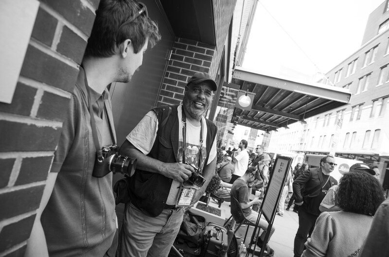 Two photographers talking outside