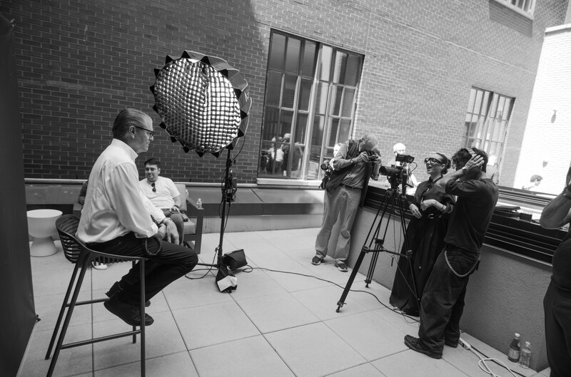 Person being interviewed on a grey backdrop