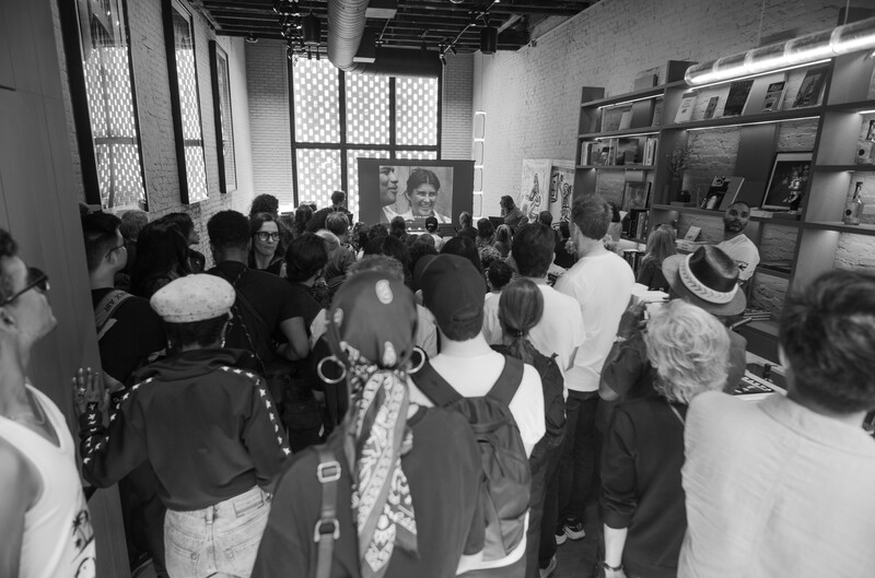 People watching on-screen presentation inside a Leica store