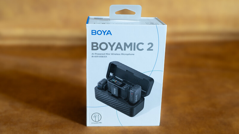 BOYA BOYAMIC 2 wireless microphone system packaging displayed against a wooden background.