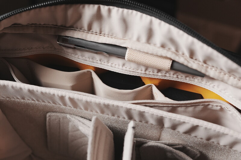 Interior of a camera bag with padded dividers and organized compartments for equipment storage.