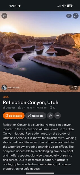 Canyon landscape with still water reflecting golden sunrise light between red rock formations.