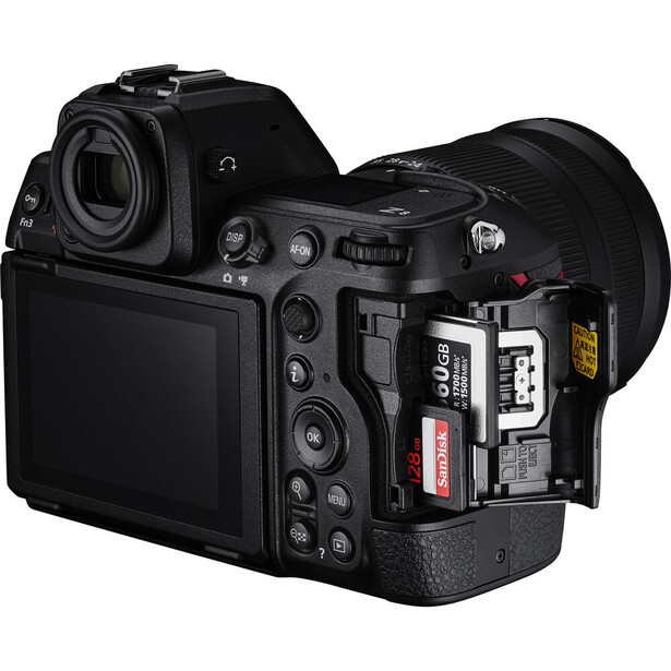 Mirrorless camera shown from above with open memory card doors revealing dual card slots.