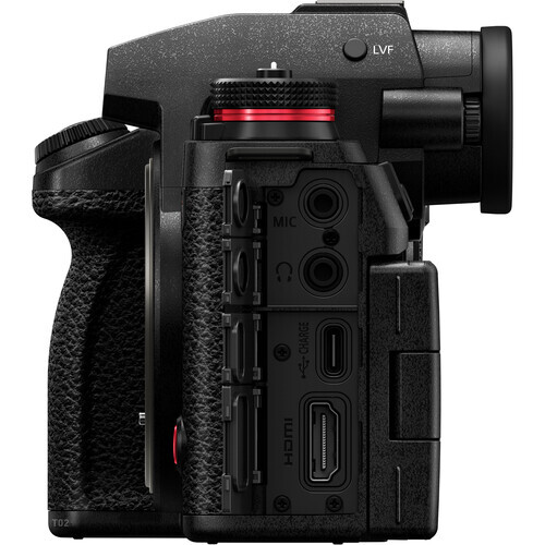 Side view of a mirrorless camera body showing ports, controls, and grip against white background.