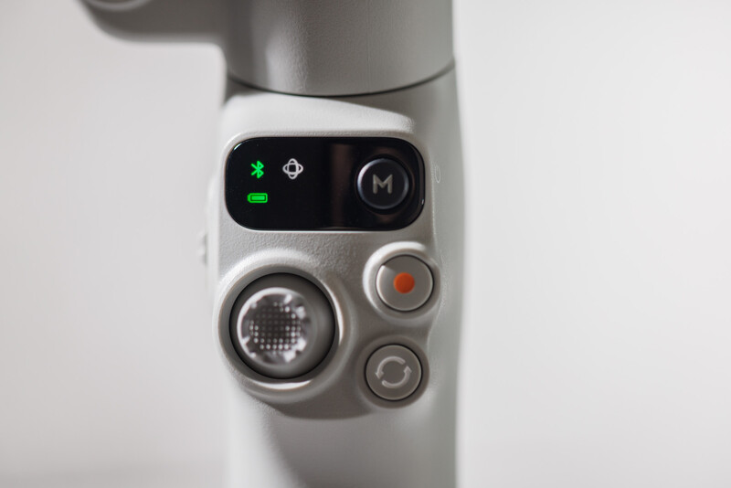 Close-up of a gimbal controller showing illuminated control buttons and a joystick interface.