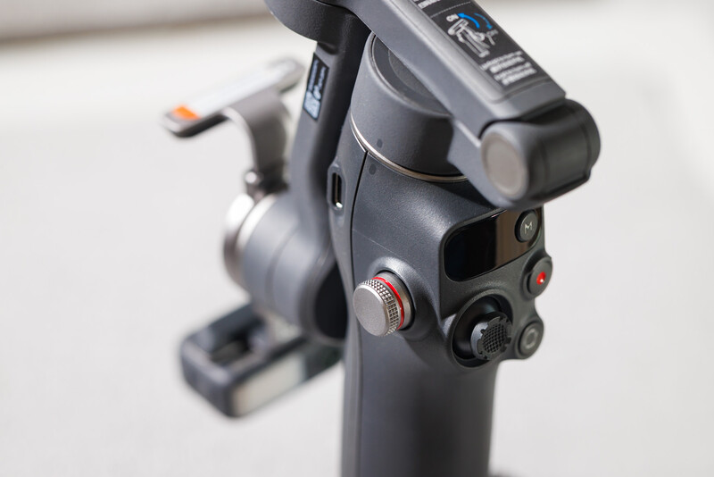 Close-up of a camera gimbal's pan-tilt head with control buttons and adjustment dials.
