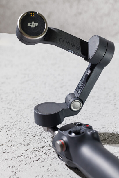 DJI gimbal stabilizer mounted on camera rig against concrete surface.
