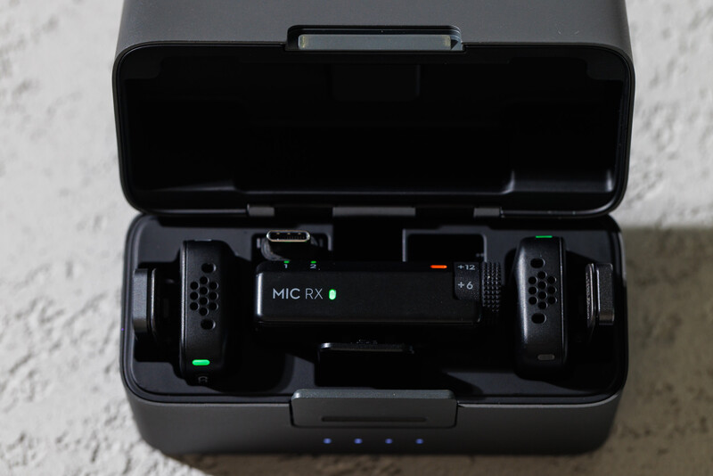Wireless microphone system with receiver and transmitter units displayed in open carrying case.