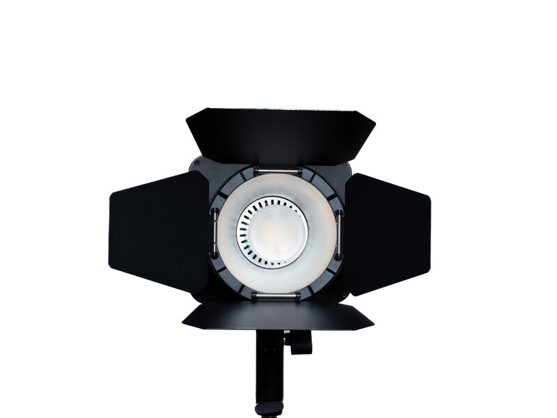 Studio LED light with circular reflector and adjustable barn doors viewed from above.