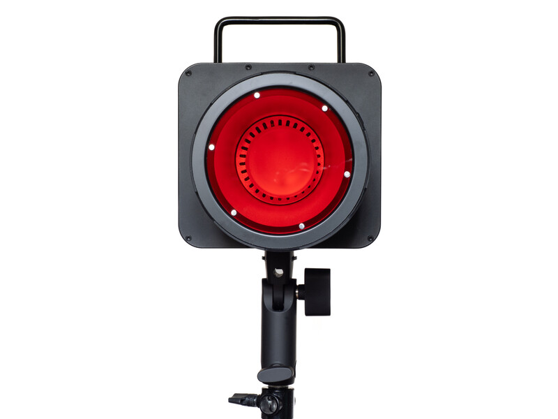 Red studio light with square housing, handle, and adjustable mounting bracket against white background.