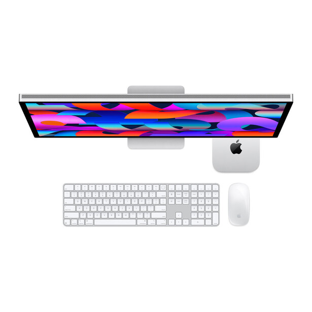Desktop setup displaying a monitor with vibrant multicolored abstract wallpaper, paired with wireless keyboard and mouse.