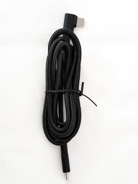 Coiled black cable with right-angle connector and single-pin termination on white background.