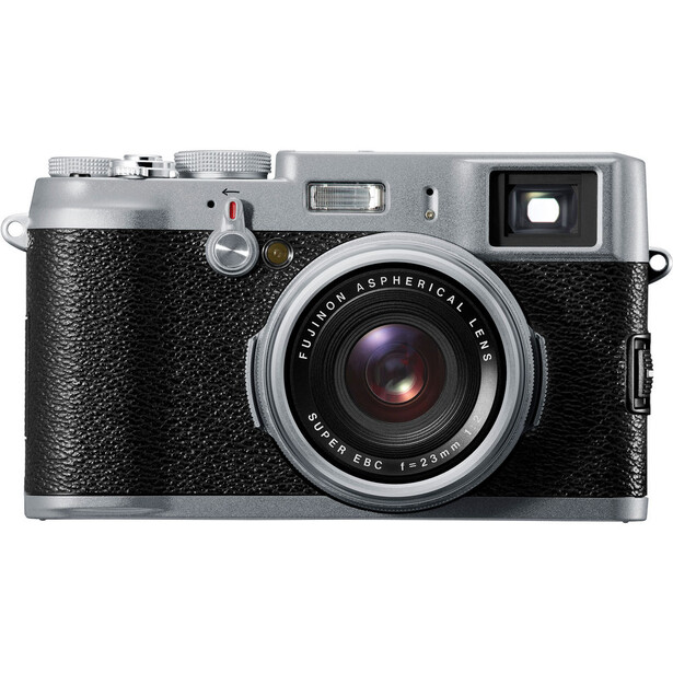 Fujifilm X100 rangefinder camera with silver top plate and textured black body.