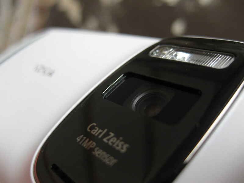 Close-up of a smartphone camera module showing Carl Zeiss optics branding and flash unit.
