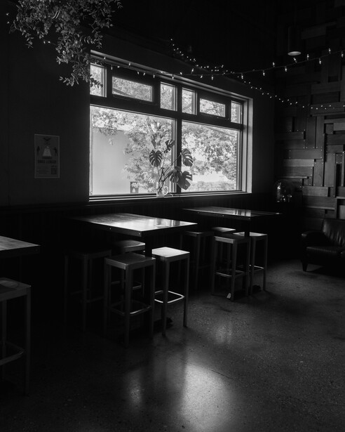 Black and white photo of window inside a brew pub