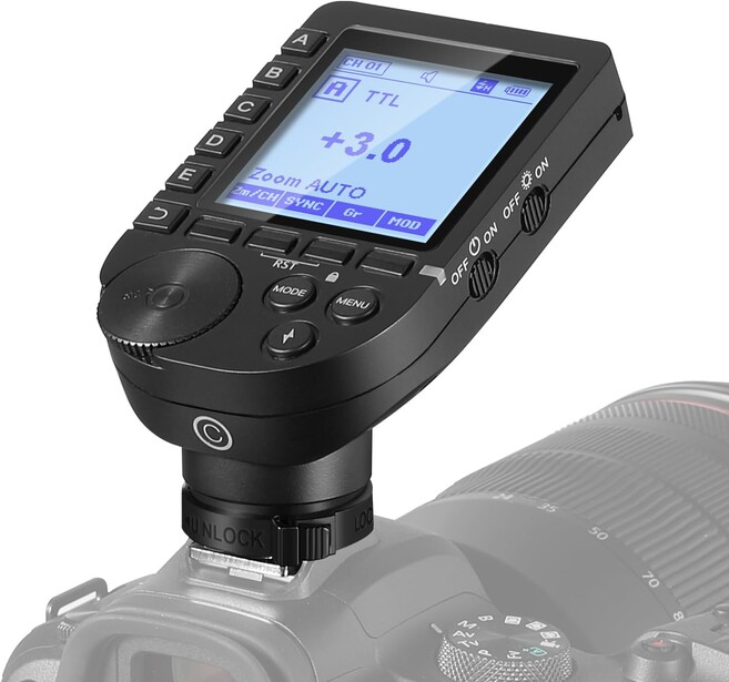 Wireless flash trigger mounted on camera hot shoe with LCD screen displaying exposure compensation settings.