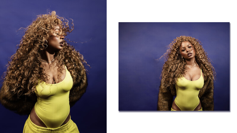 Woman with voluminous curly hair wearing a lime green bodysuit against a deep blue background.