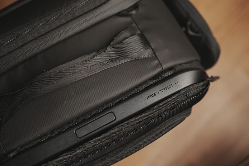 Close-up of a black camera bag's interior compartments with protective padding and fabric straps.