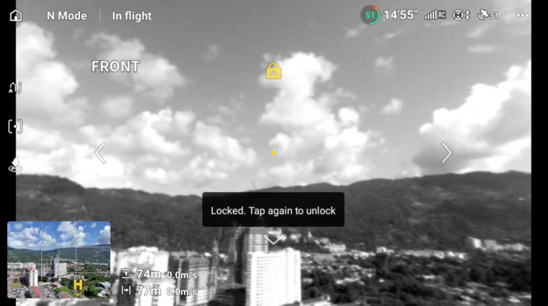 Screenshot of drone camera interface showing locked thermal/infrared feed of mountainous landscape with buildings.