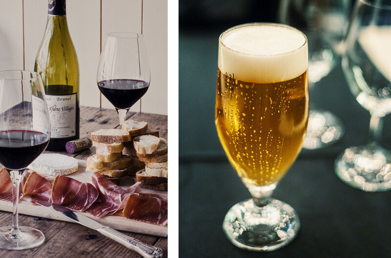 Wine and charcuterie board with glasses of red wine alongside a beer glass with foam head.