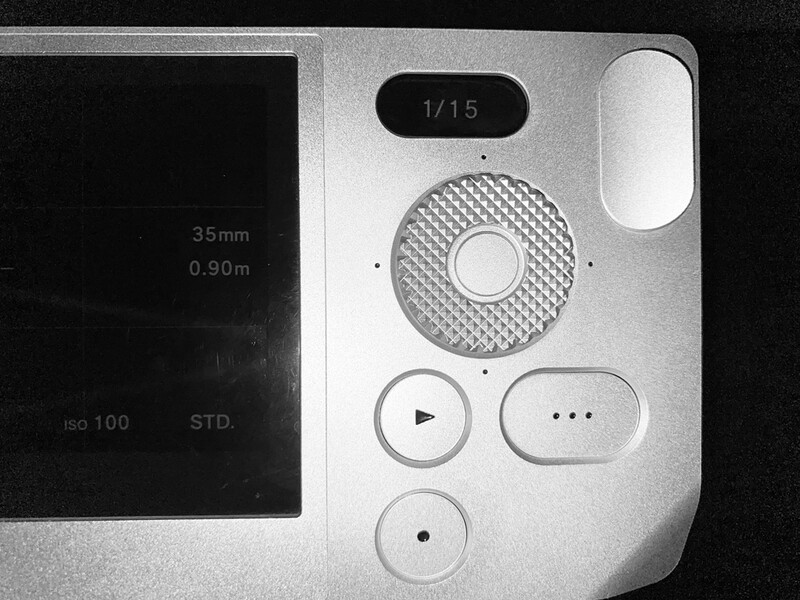 Overhead view of a smartphone camera interface showing manual controls, lens specifications, and shooting parameters.