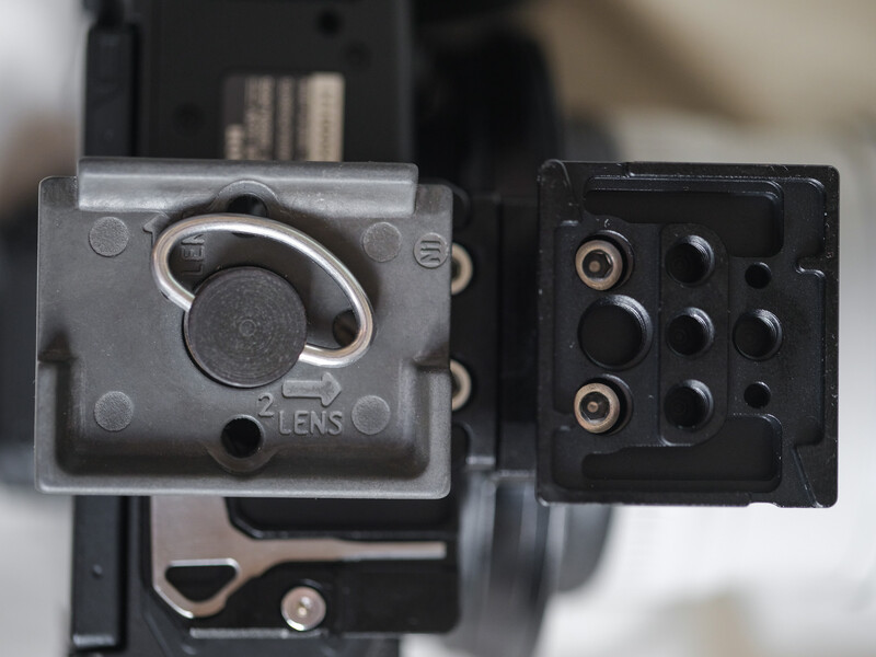 Close-up of a camera lens mount and adapter showing mechanical components and connection ports.